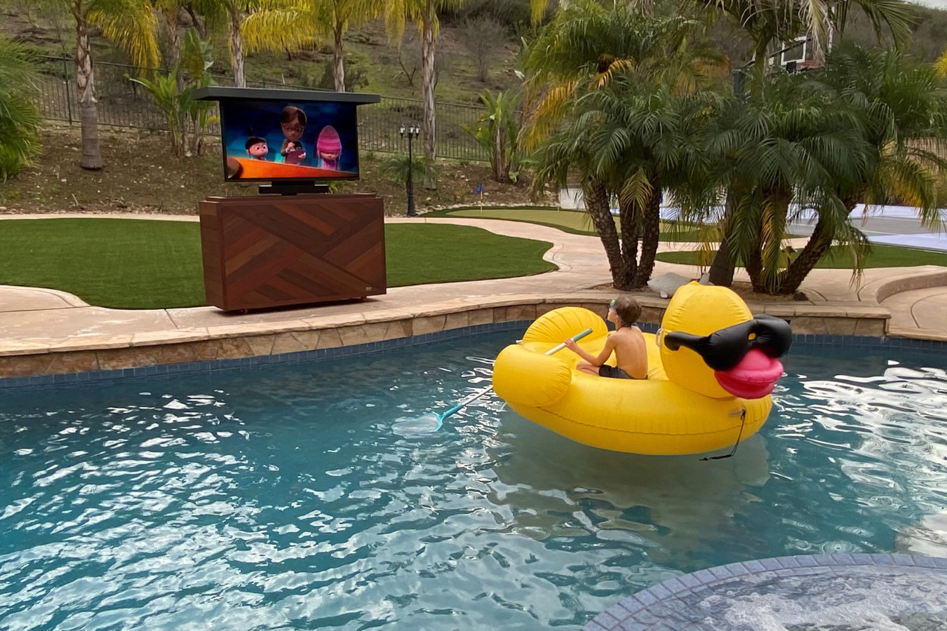 Outdoor TV lift cabinet by pool hides and reveals waterproof TV by Cabinet Tronix