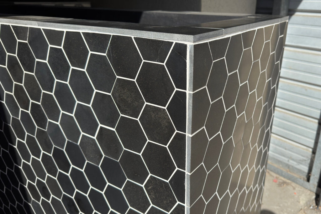 black octagon tile tv lift cabinet close up